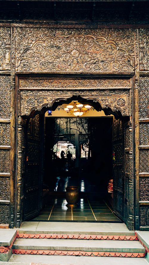Free A beautifully carved antique door leading to a historic interior in Udaipur, India. Stock Photo