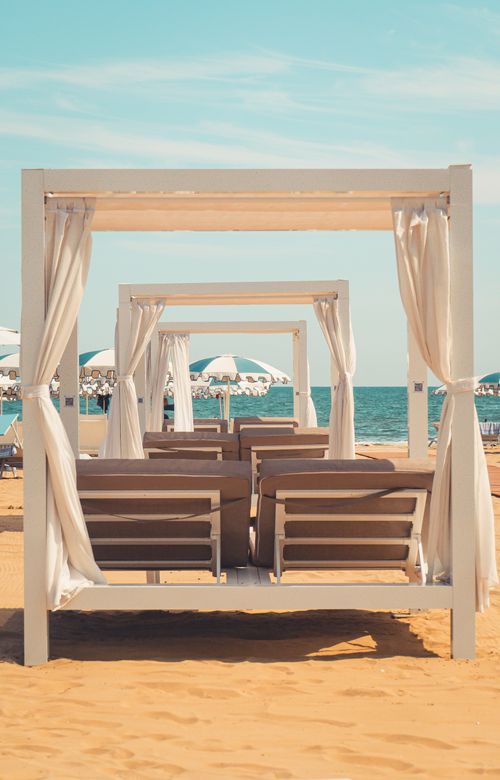 Free Elegant beach cabana setup on a sandy Venetian beach with a stunning sea view. Stock Photo