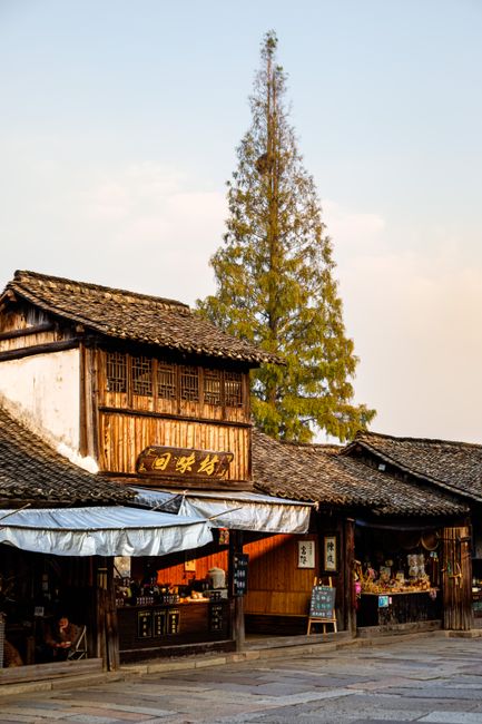 A picturesque view of a traditional wooden market street in China, showcasing local culture.