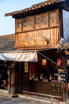 Scenic view of a traditional wooden shop in a historic Chinese village with wooden architecture.