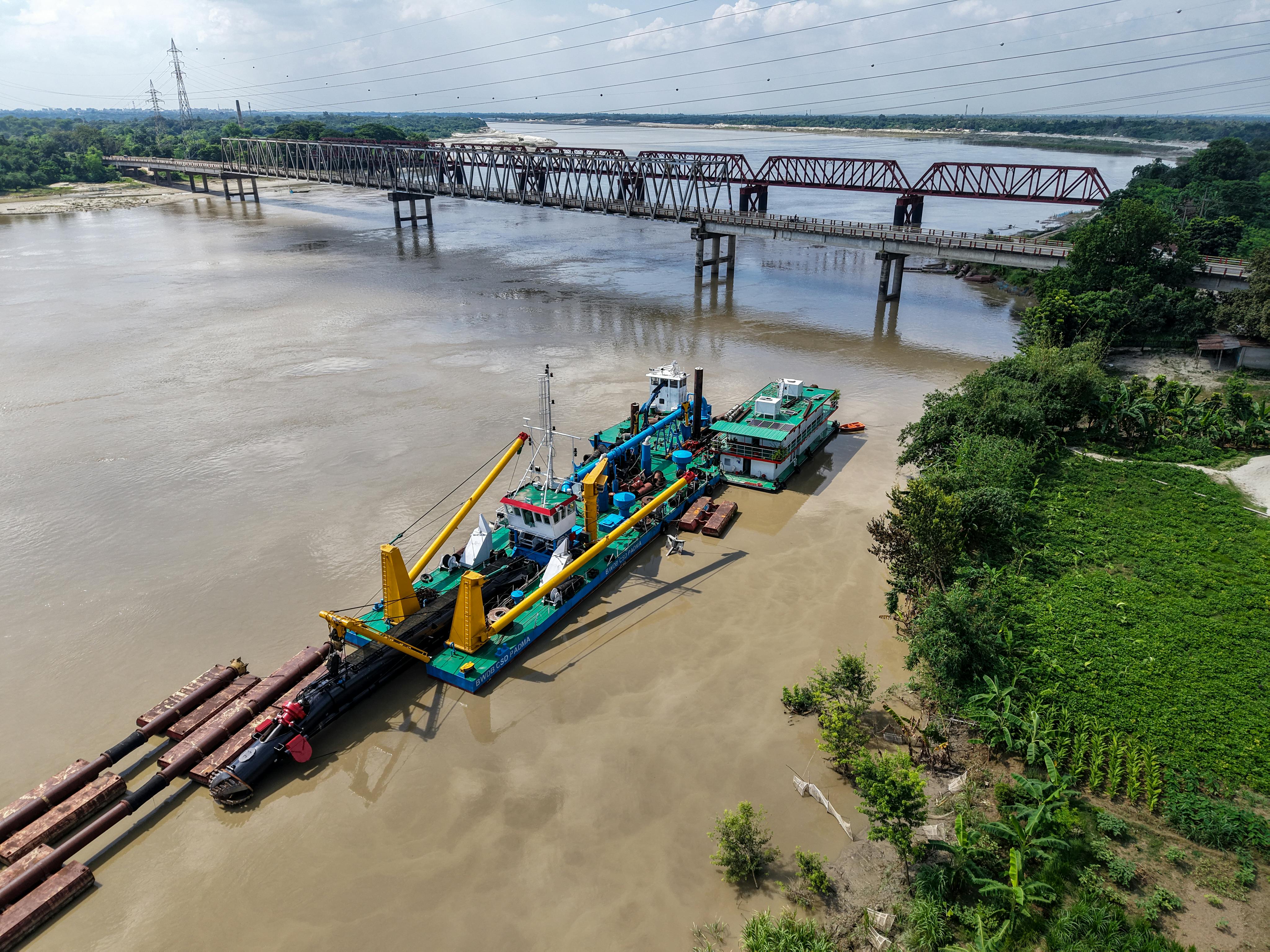 A 4-inch gold dredge in operation on a river - 6 inch gold dredge for sale
