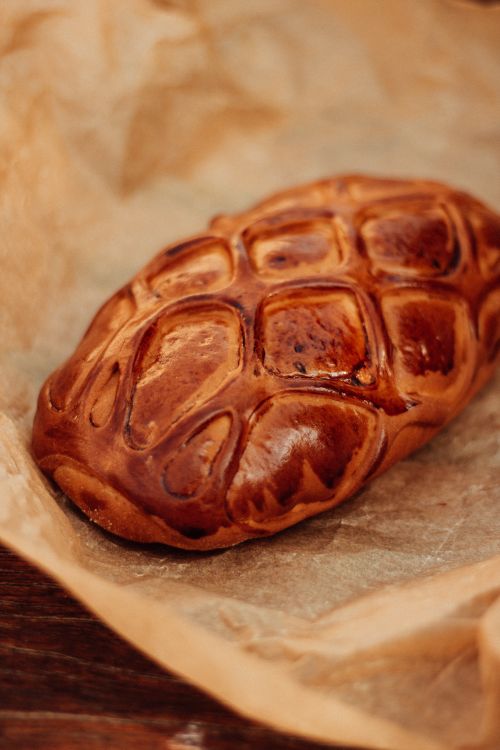 Free Golden-brown Georgian sweet pastry with a lattice design, baked to perfection on parchment paper. Stock Photo