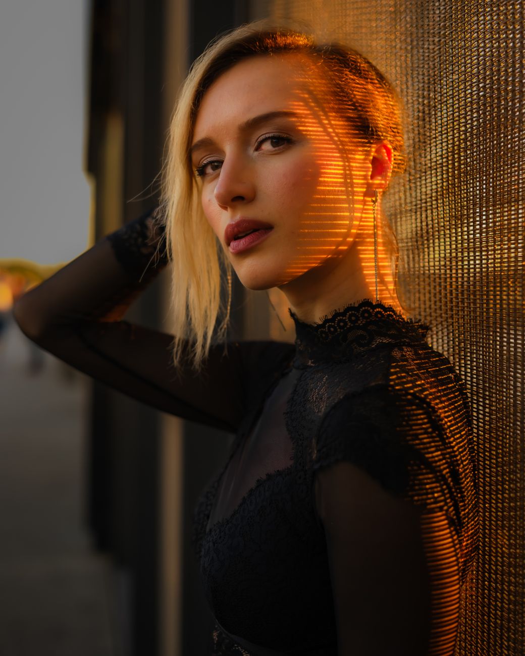 Striking portrait of a woman with urban backdrop during golden hour lighting.. striking, portrait, woman