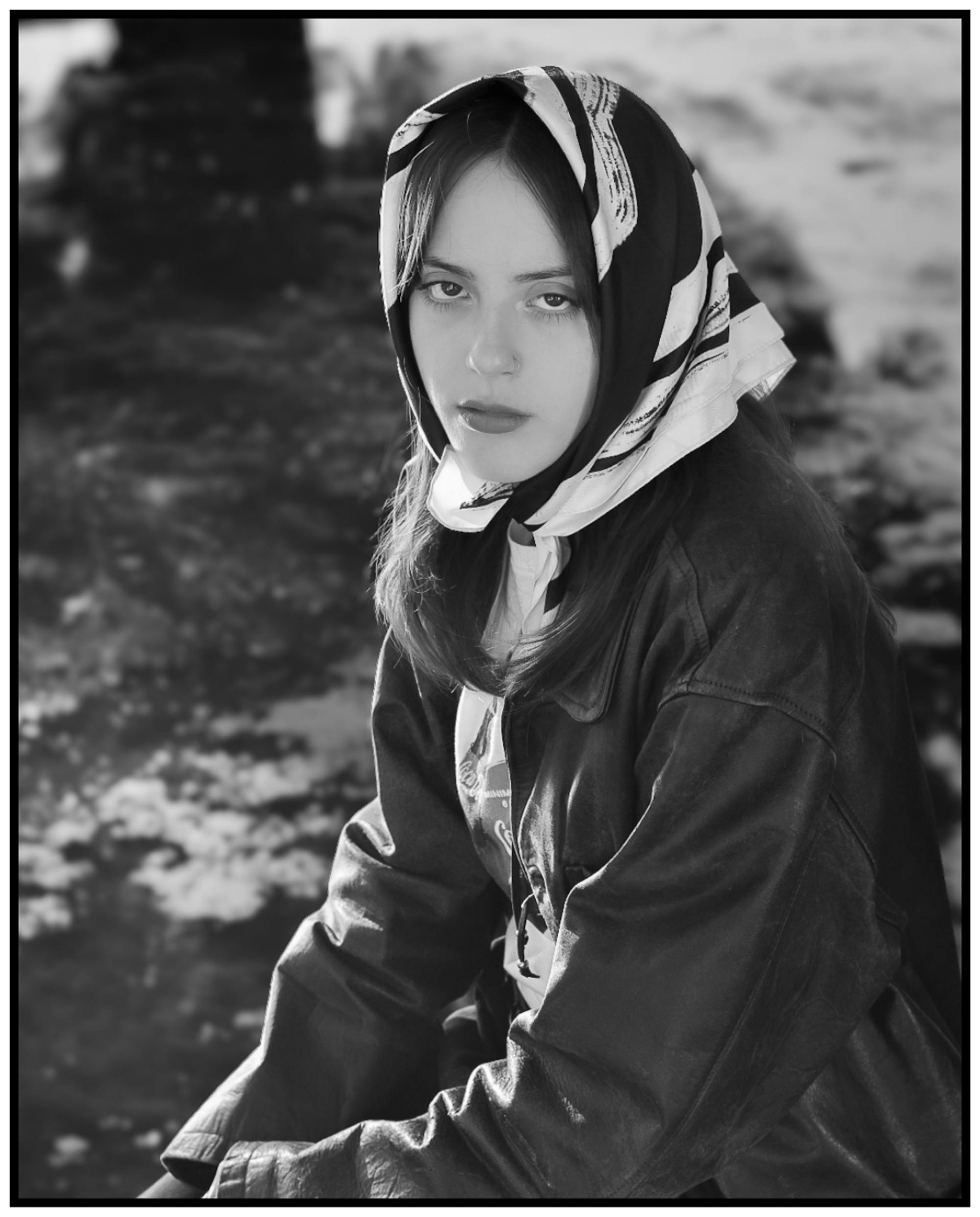 Monochrome portrait of a woman wearing a headscarf outdoors in Rosario, Argentina.