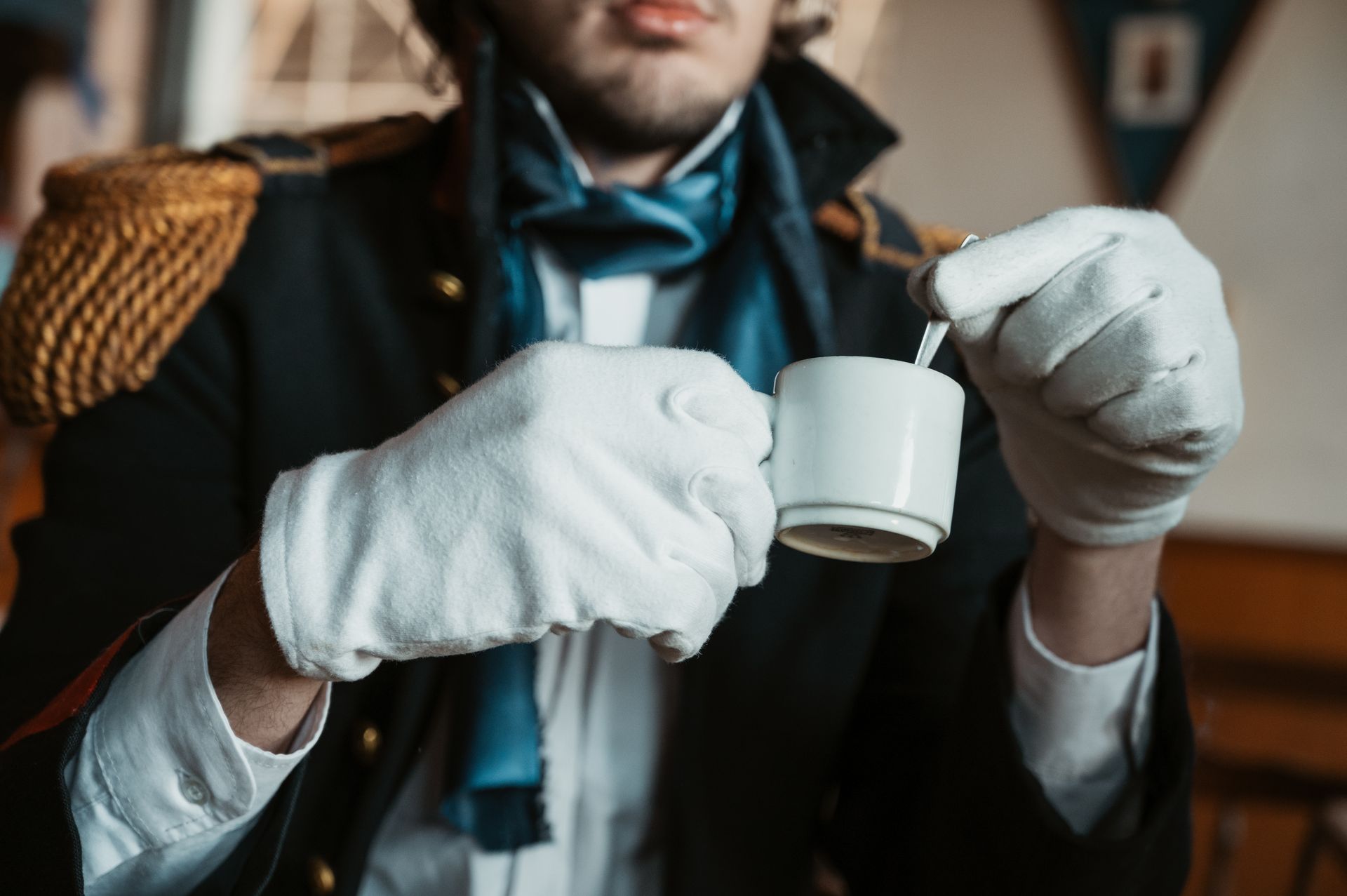 A man in historical attire enjoys a coffee in Buenos Aires, Argentina, creating a vintage ambiance.