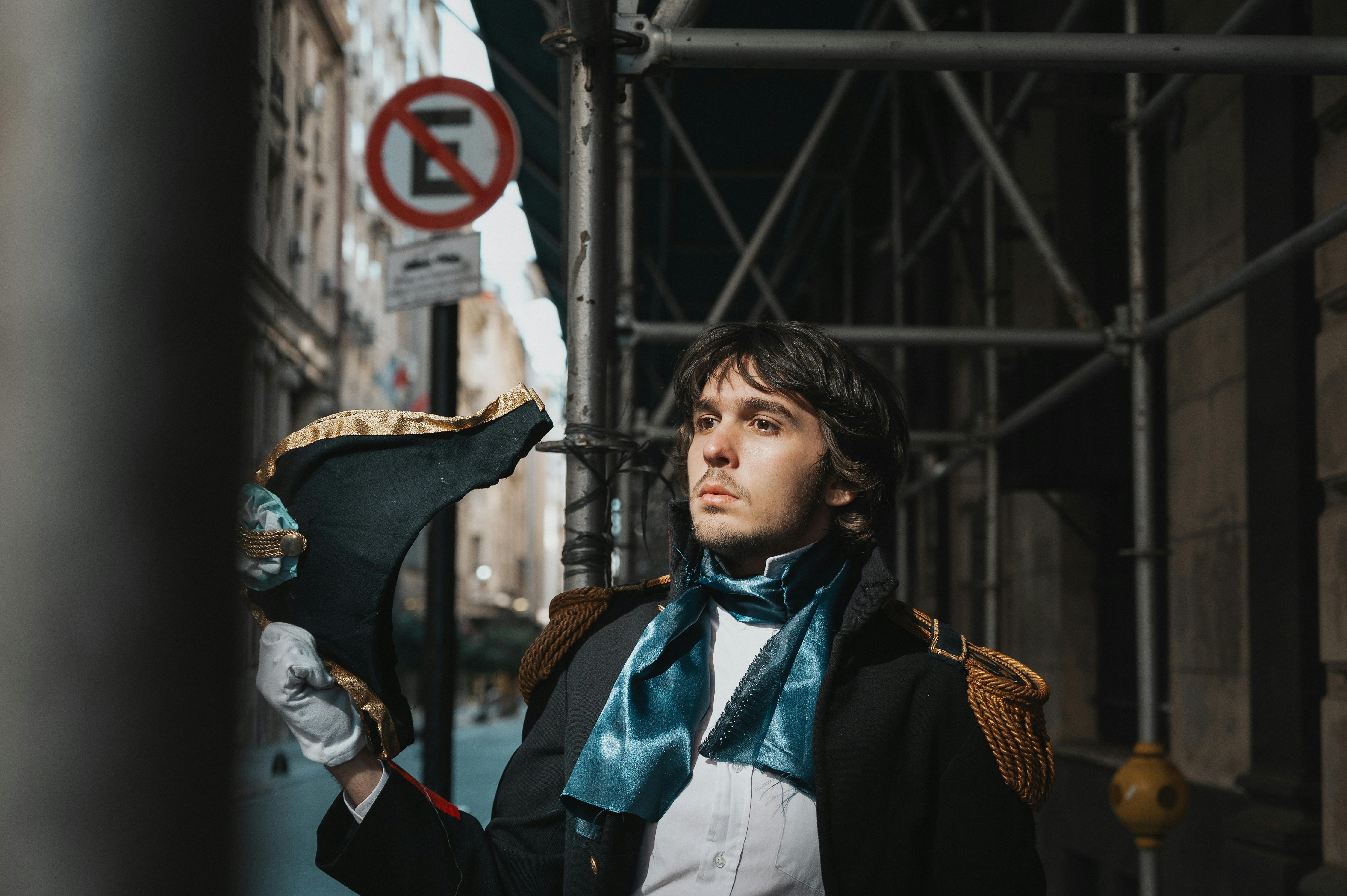 A man dressed in historical attire poses on a city street in Buenos Aires, Argentina.