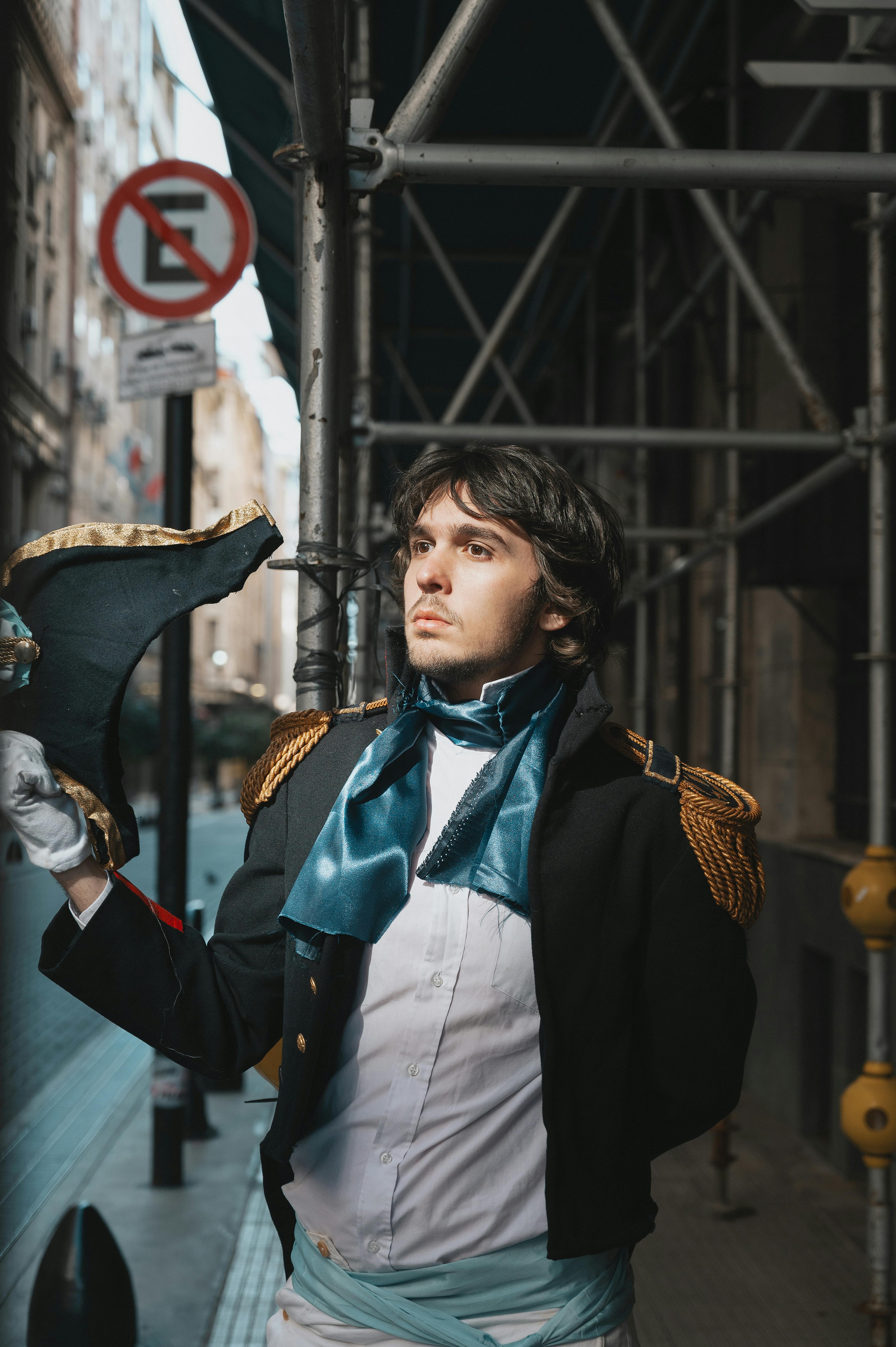Young adult in historical costume posing outdoors, Buenos Aires street setting.