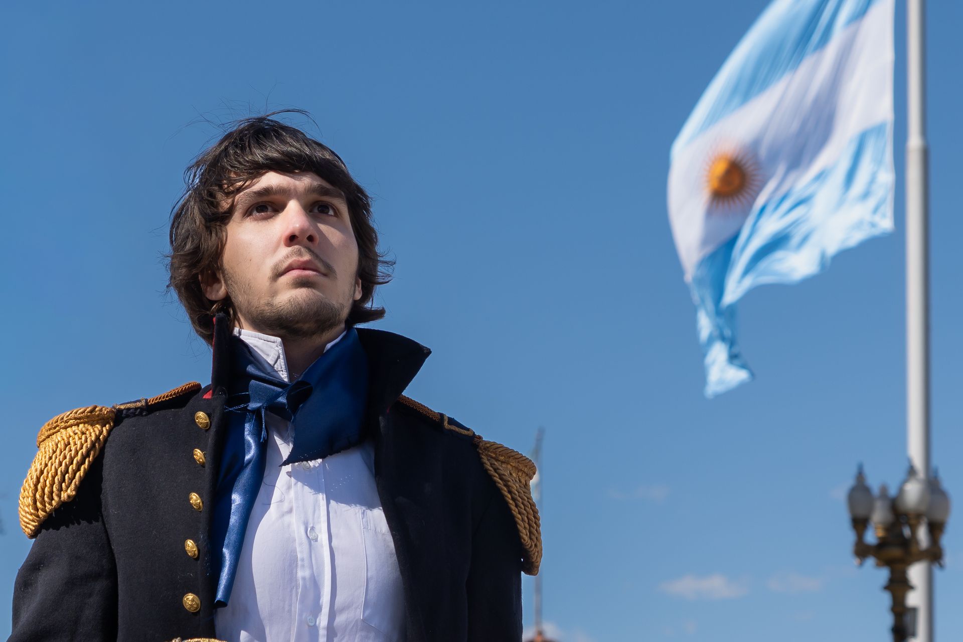 Portrait of a historical figure in uniform with the Argentine flag in Buenos Aires.