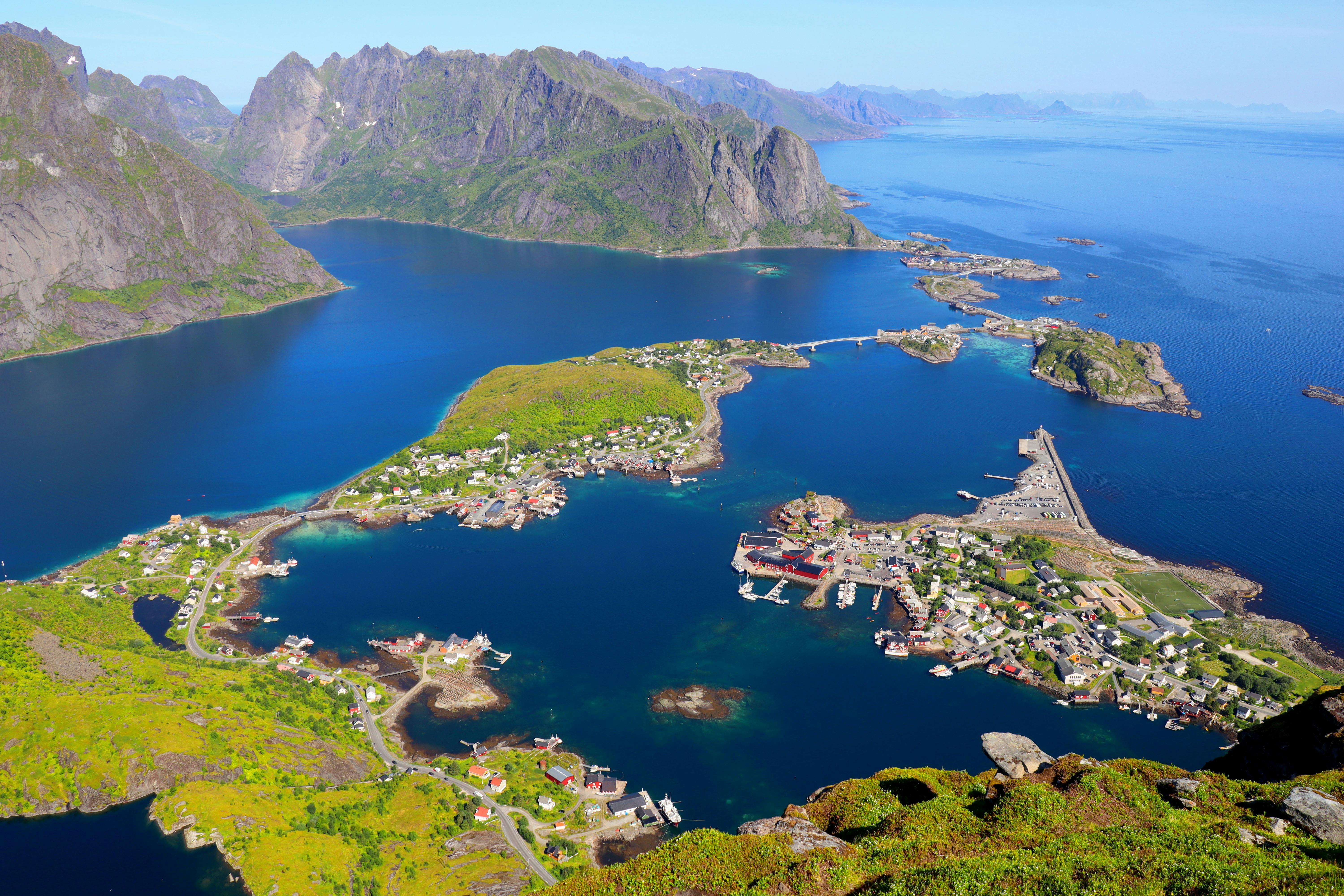 Stunning aerial shot of coastal village surrounded by mountains in Lofoten Islands, Norway.