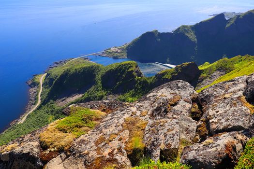 Dramatic landscape of cliffs, ocean, and road from mountain summit. Breathtaking view.
