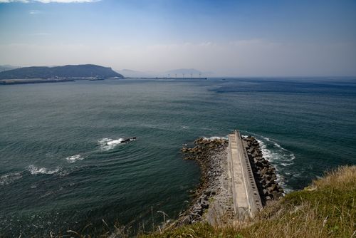 Free A peaceful seascape with a breakwater extending into the ocean at Sopelana, País Vasco, España. Stock Photo