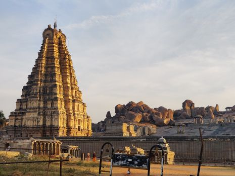 Stunning view of Virupaksha Temple with rocky landscape in Hampi, India.