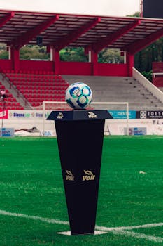 A soccer ball displayed on a pedestal in Tlaxcala stadium, Mexico, highlighting sports venue ambiance.