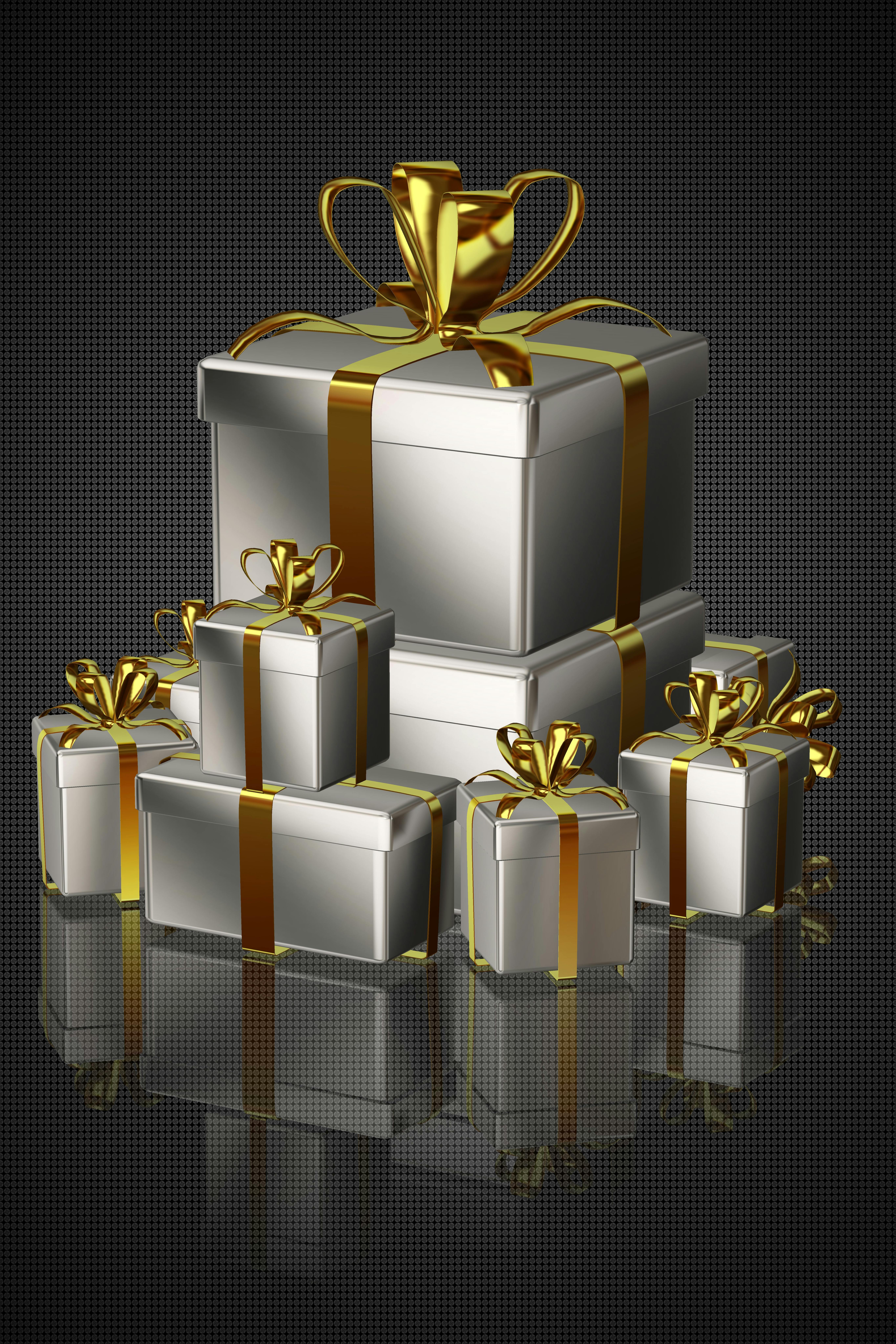 Luxurious silver gift boxes with gold ribbon, perfect for holidays and special occasions.