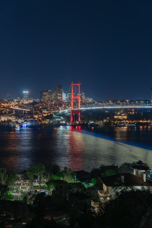 Free Captivating nighttime view of the illuminated Bosphorus Bridge in Istanbul with city skyline backdrop. Stock Photo