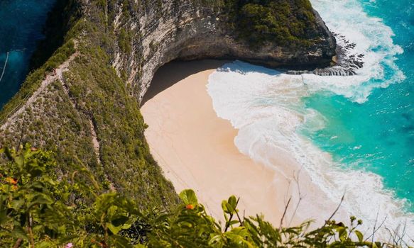 Discover the breathtaking beauty of Kelingking Beach, Bali, with crystal-clear waters and lush cliffs.