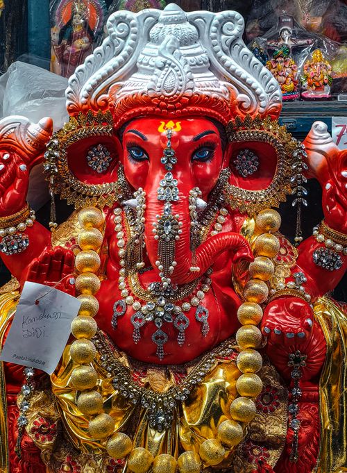 Free Colorful and intricately decorated statue of Lord Ganesha with jewels and ornaments. Stock Photo