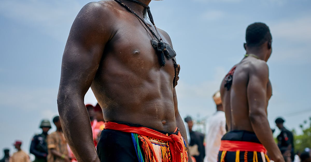 Two African men in traditional attire participating in an outdoor wrestling event. Local SEO Checklist