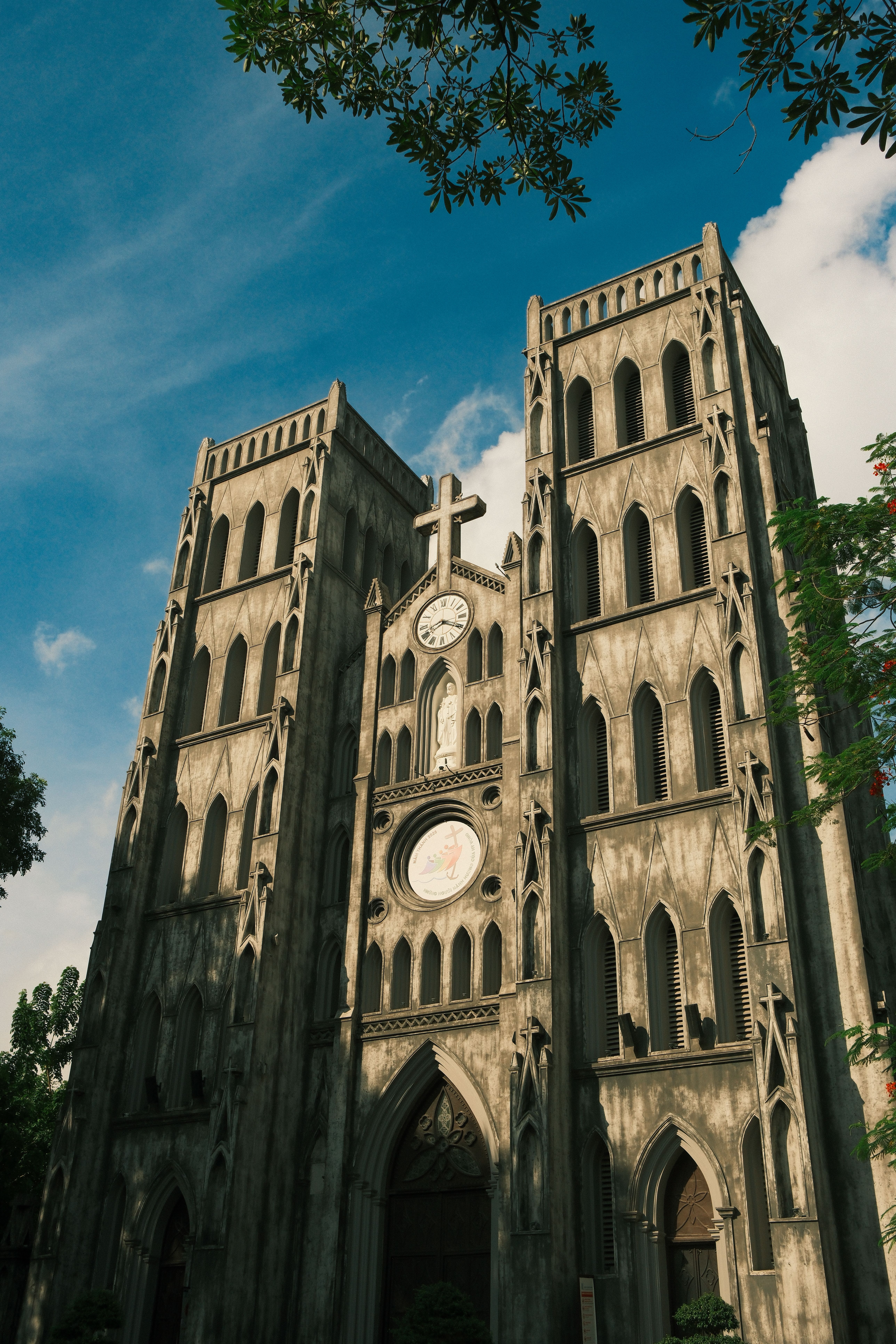 A stunning view of St. Joseph's Cathedral in Hà Nội, showcasing its Gothic Revival architecture under a vibrant sky.