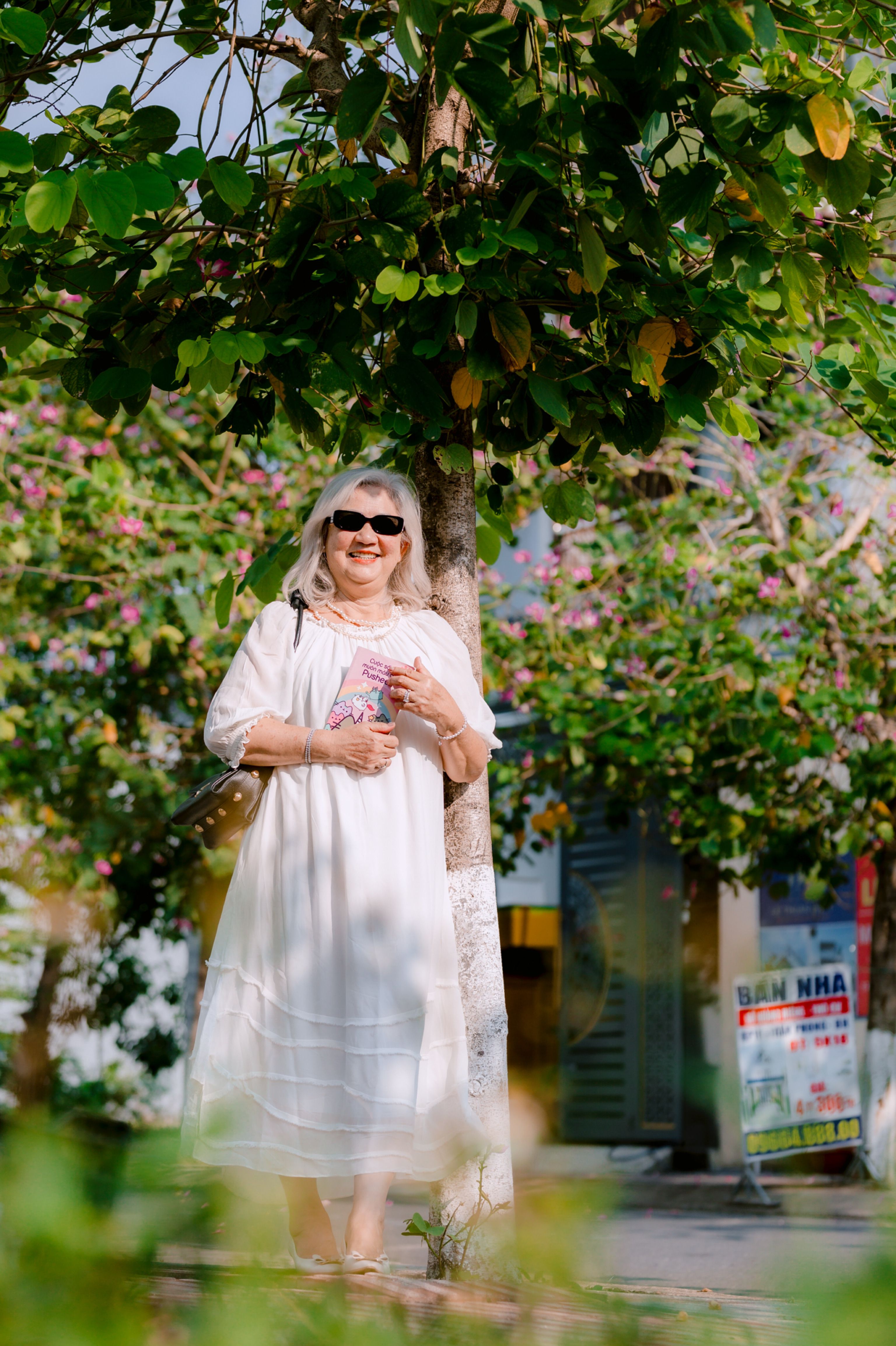 Smiling Woman in White Dress Under Tree on Sunny Day · Free Stock Photo