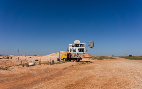 Entrance to a working opal mine set against the arid landscape of Coober Pedy, Australia.