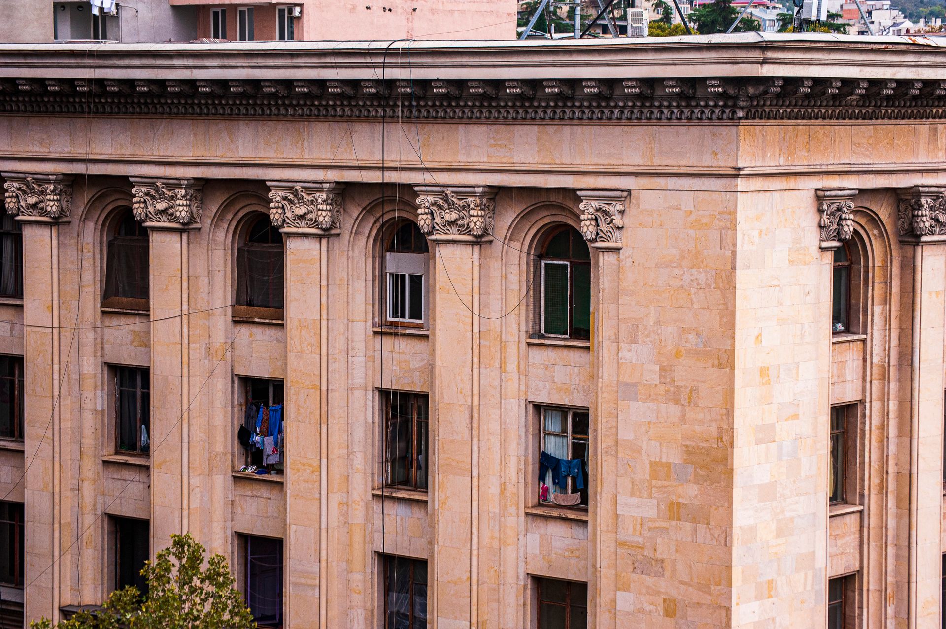 Detailed facade of a classical building featuring Corinthian columns and intricate carvings.