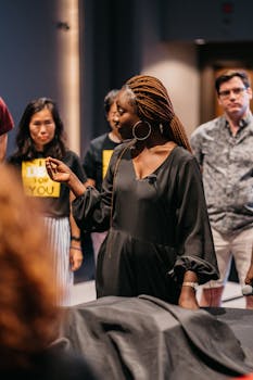 A diverse group of adults participating in an engaging indoor workshop setting, fostering teamwork and collaboration.