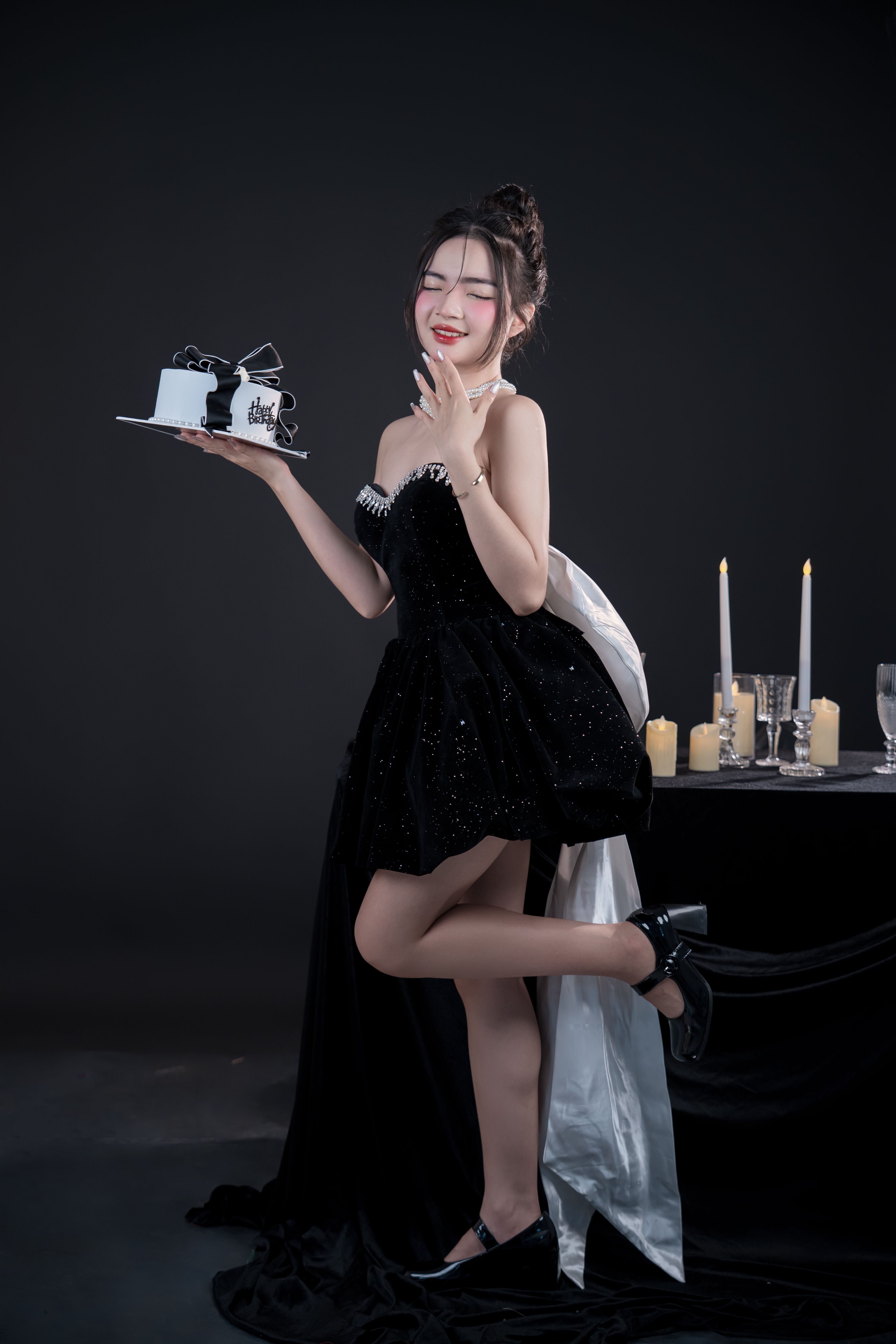 Woman restyling her little black dress for a Christmas party