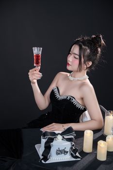 Woman in elegant dress holding a champagne glass at a celebration.
