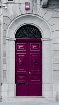 Explore the vibrant charm of a purple door set against historic Maltese architecture, showcasing unique Mediterranean style.