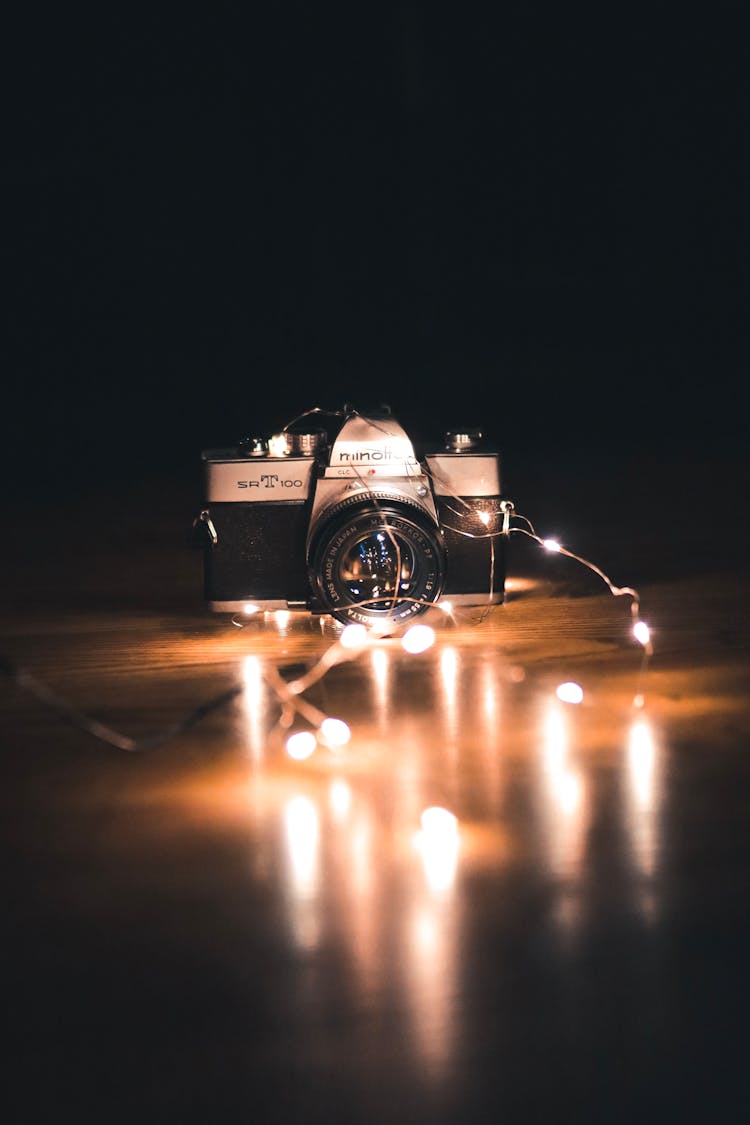 Photo Of Camera Near String Lights