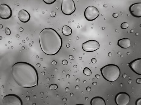 Close-up view of raindrops on a glass window, capturing the beauty of water droplets.