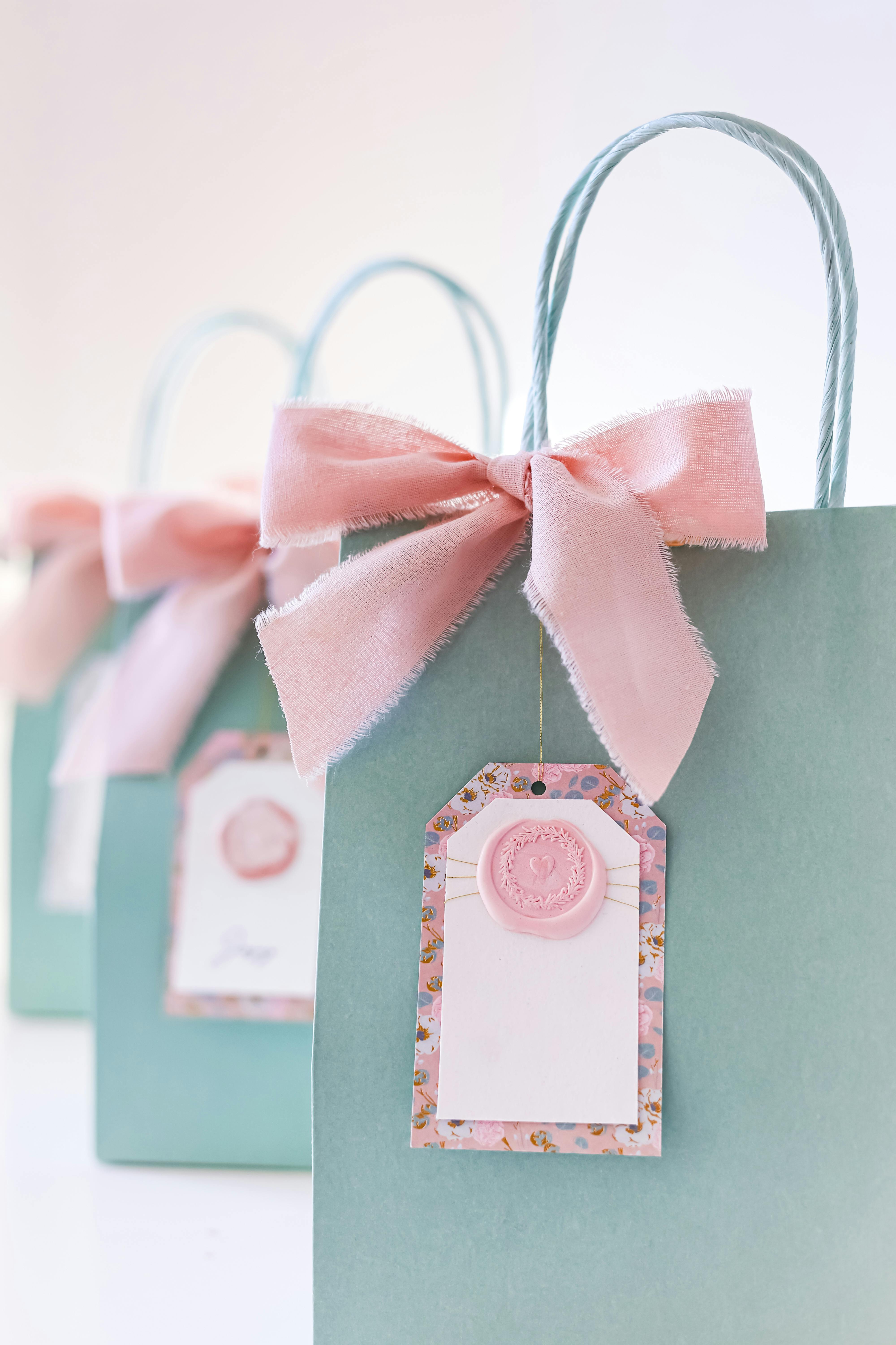 Chic gift bags adorned with pink bows, perfect for celebrations or parties.