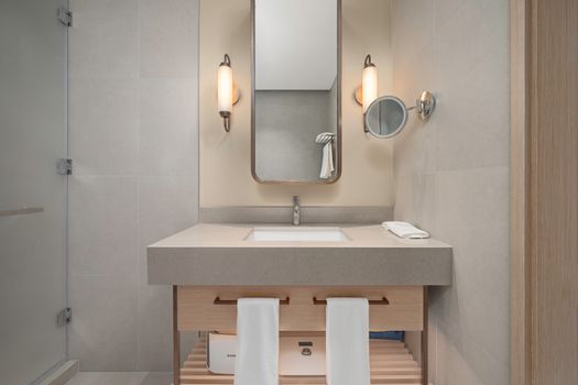 Elegant bathroom with a modern vanity, soft lighting, and a large mirror.