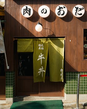 Wooden storefront with noren curtain in Japan, highlighting cultural aesthetics in vibrant street setting.
