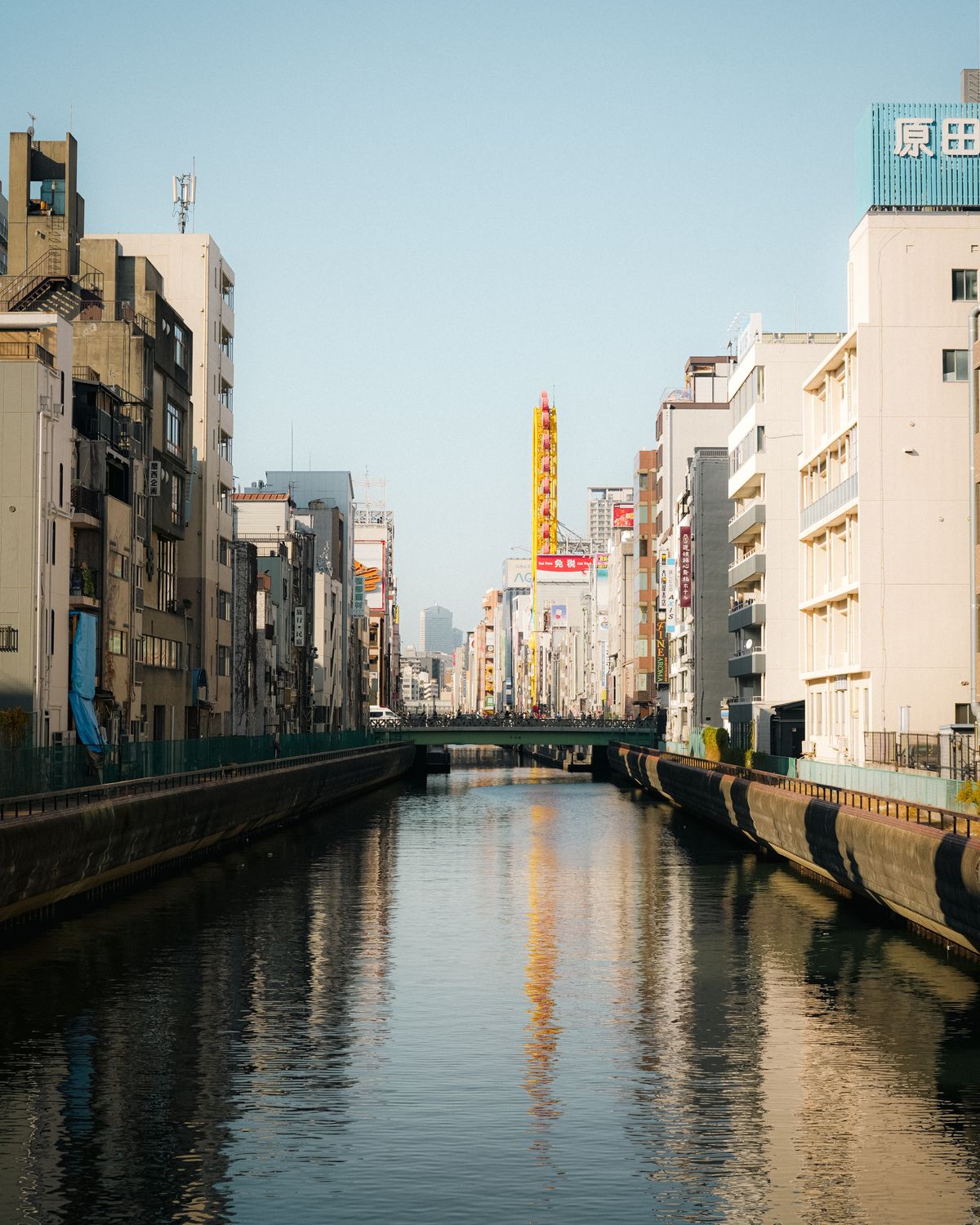 Urban reflections along a canal surrounded by Japanese architecture