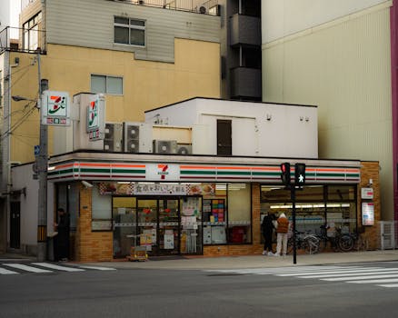 Candid street photo of a 7-Eleven convenience store in Japan.