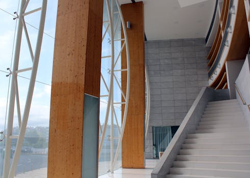 Bright, modern lobby interior with ascending staircase and large windows in Ponta Delgada.