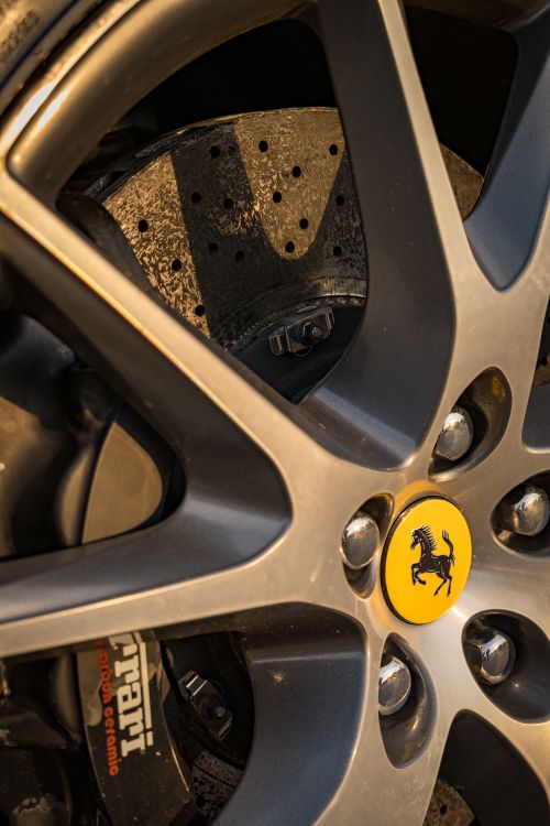 Free Detailed view of a Ferrari brake disc and wheel showcasing precision engineering and luxury. Stock Photo