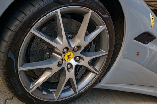 Free Detailed close-up of a Ferrari wheel and high-performance tire showing luxury and design. Stock Photo