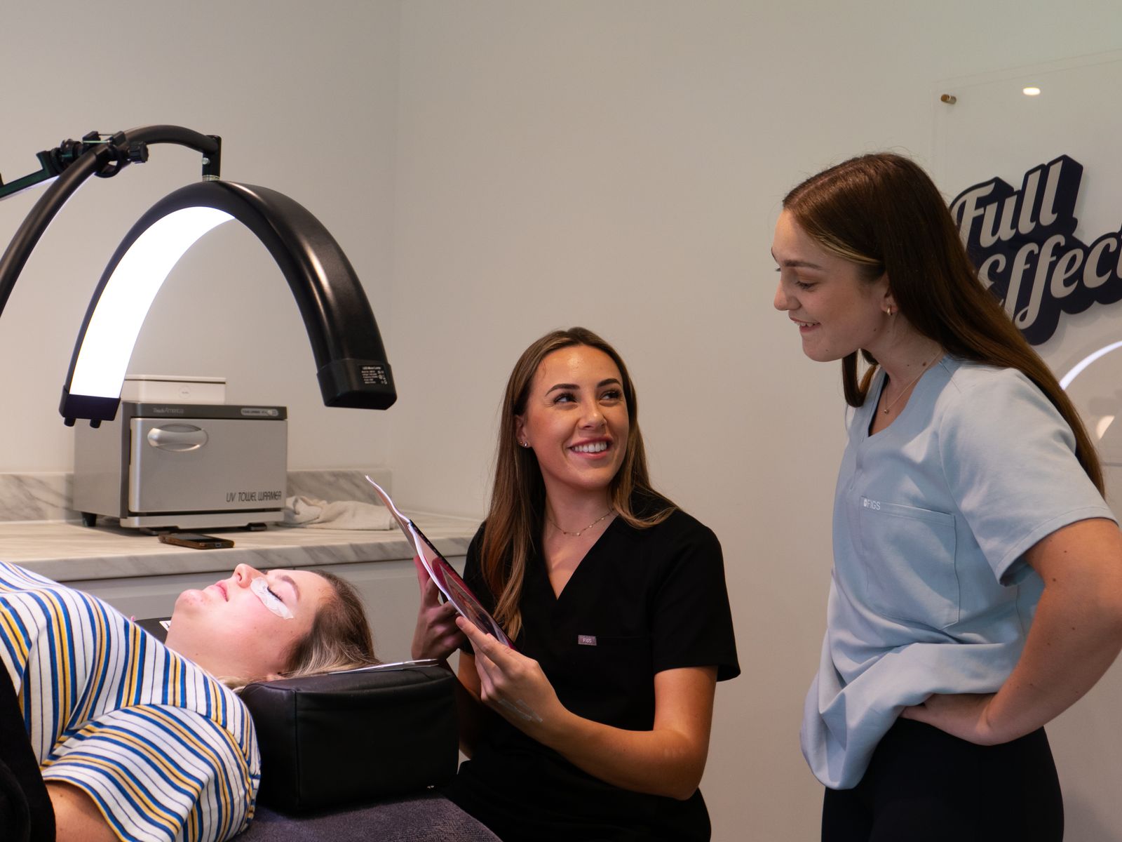 Dermatology consultation with clinicians and a patient in a modern clinic