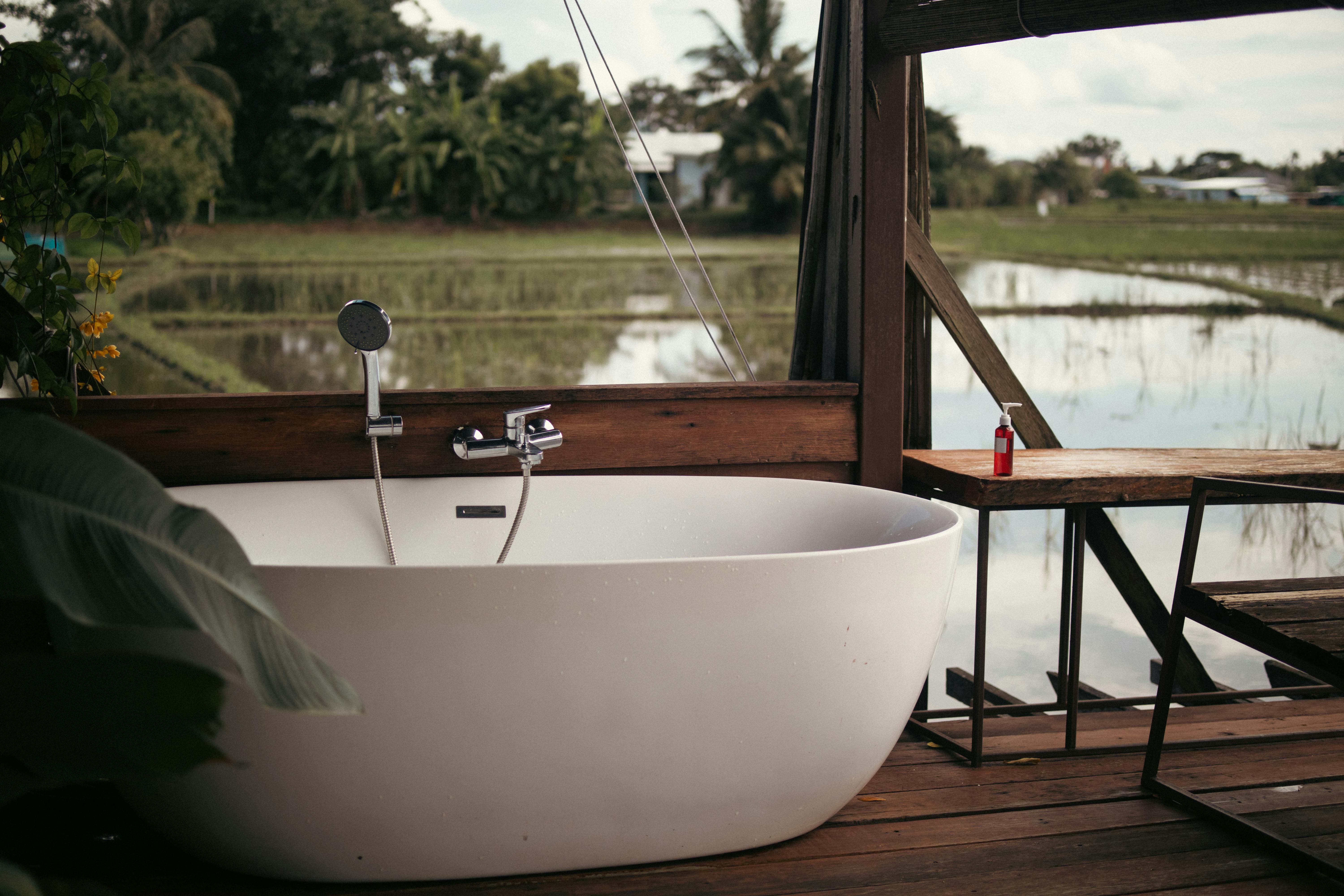 Open-air bathtub with rice paddy view in an Ubud jungle villa at a luxury Bali honeymoon resort