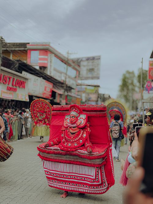 Free Vibrant Theyyam performer captivates Ernakulam street crowd, Kerala, India. Stock Photo