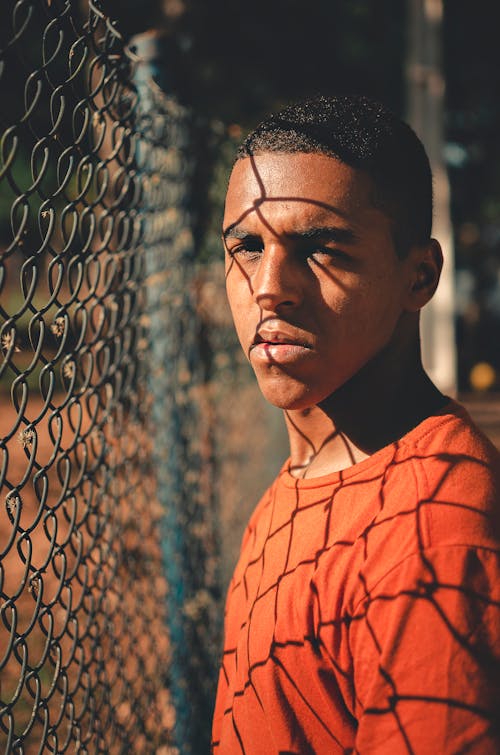 Free Photo Of Man Near Chain Link Fence Stock Photo