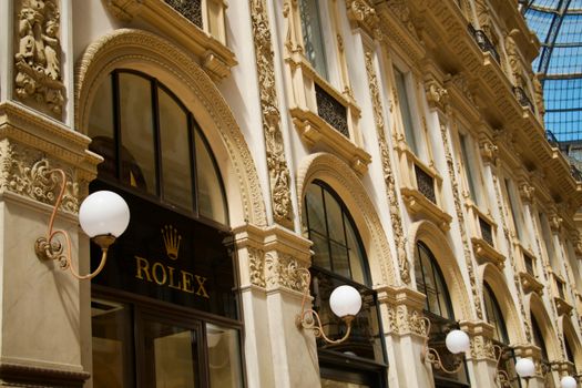 A close-up exterior view of the ornate architecture at the Galleria Vittorio Emanuele II in Milan, Italy.
