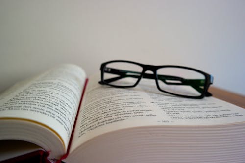 Free Close-up of Eyeglasses on Book Stock Photo
