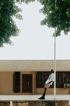 Stylish male portrait with African cultural style set against urban Ibadan backdrop.