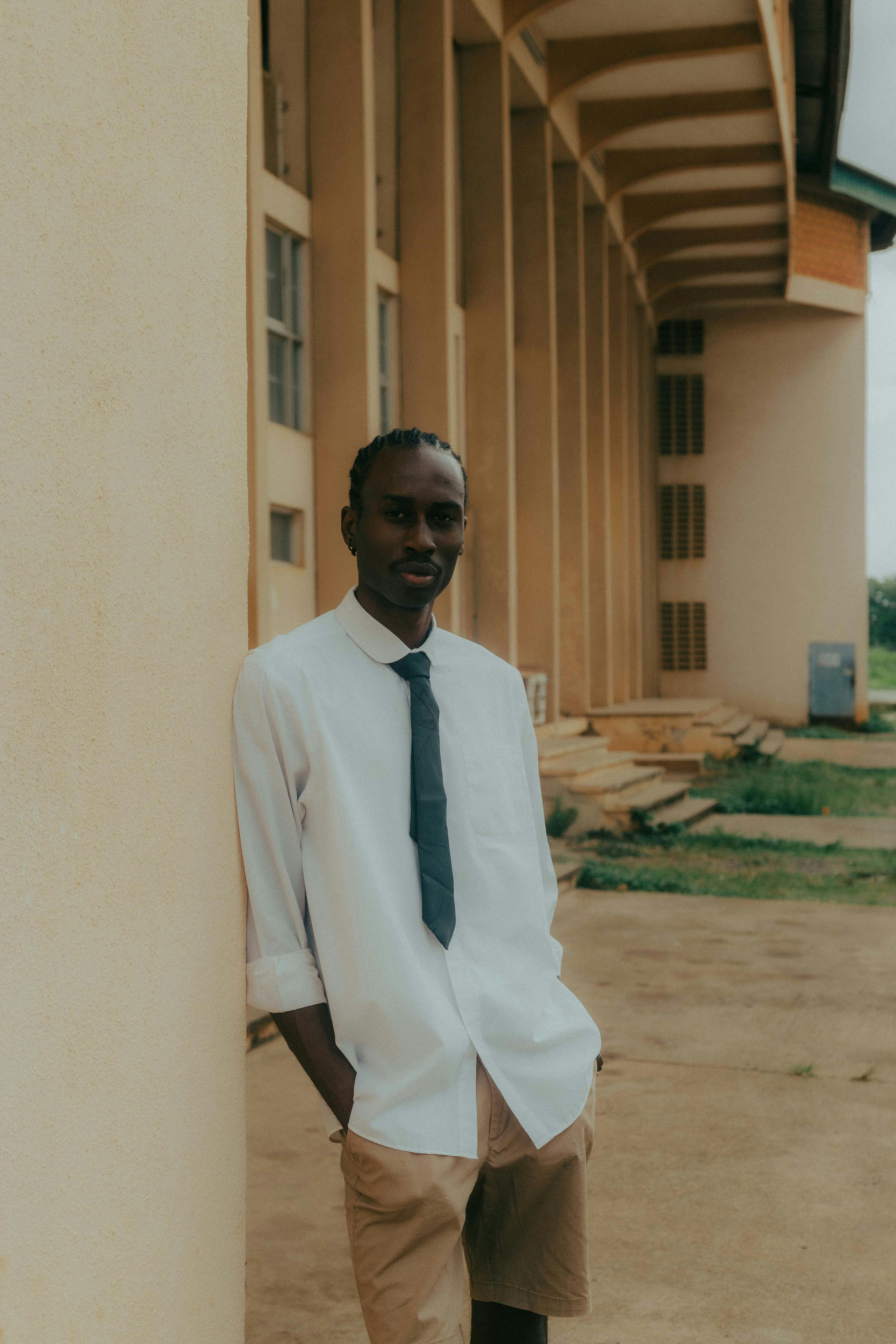 A stylish portrait of a man in Ibadan, Nigeria, showcasing cultural and modern fashion.