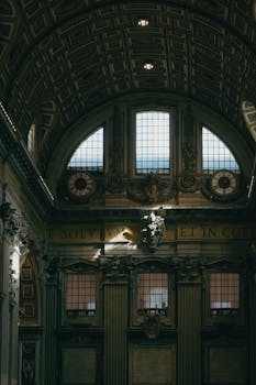 Dimly lit interior of St. Peter's Basilica showcasing ornate architecture and classic design.