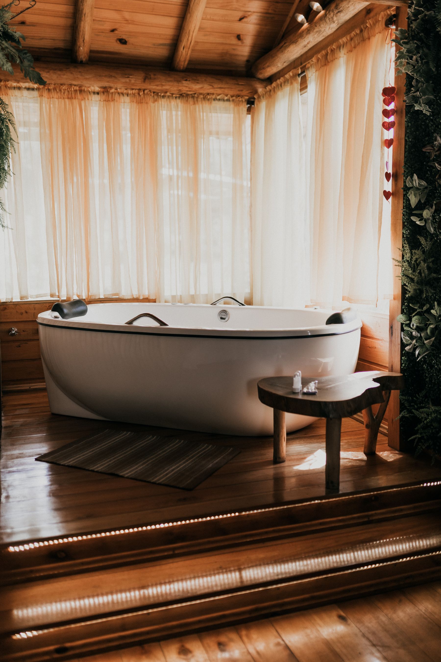 Rustic bathroom with bathtub surrounded by warm timber surfaces